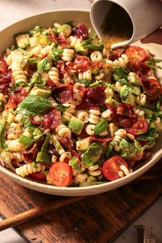 pasta salad in a serving bowl with dressing being poured over. Easy Blt Pasta Salad, Blt Pasta Salad, Blt Pasta, Cookout Side Dishes, Blt Pasta Salads, Pasta Salad Dressing, Easy Pasta Salad Recipe, Classic Sandwich, Best Pasta Salad