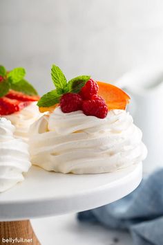 three desserts on white plates with raspberries and blueberries in the middle