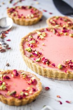 raspberry and pistachio tart with rose petals on top, ready to be eaten