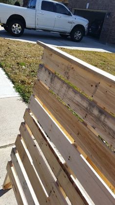 a white truck parked next to a wooden bench