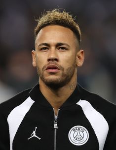 a close up of a soccer player wearing a black and white jacket