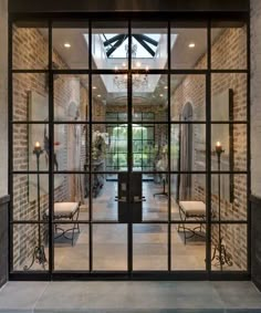 an entry way with glass doors and brick walls