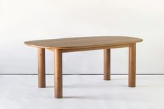 a wooden table sitting on top of a white floor