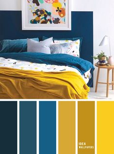 a bedroom with blue, yellow and white colors in the wall next to the bed