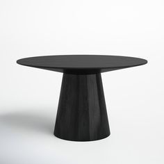 a black round table sitting on top of a white floor