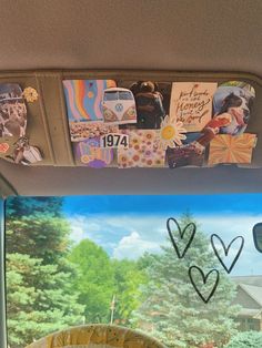 the inside of a car with pictures and hearts drawn on the side window sill