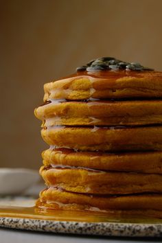 a stack of pancakes with syrup on top