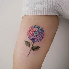 a small flower tattoo on the right thigh