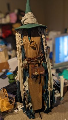 a costume made to look like a wizard's hat and cloak is displayed in front of a computer screen