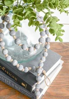 a vase filled with flowers sitting on top of two books