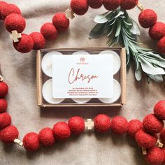 red pom - poms are laid out on the ground next to a box