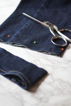 a pair of scissors and some blue jeans