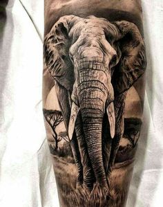 an elephant is shown on the leg and it's head has been painted with black ink