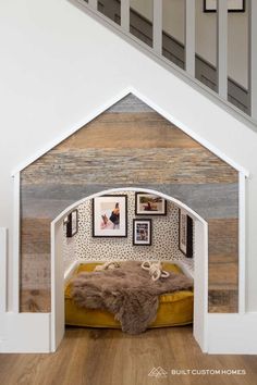 a dog house that is built into the side of a wall with pictures on it