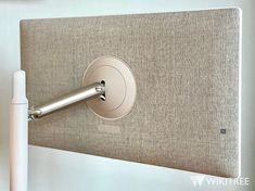 an electronic device is attached to the back of a headboard with a metal handle