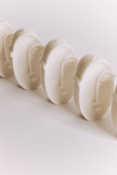 four white plastic knobs lined up in a row