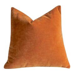 an orange pillow on a white background