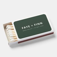 a matchbox filled with matches on top of a white table