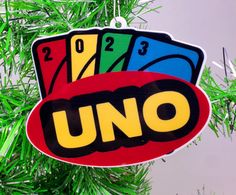 a christmas tree ornament with uno cards hanging from it