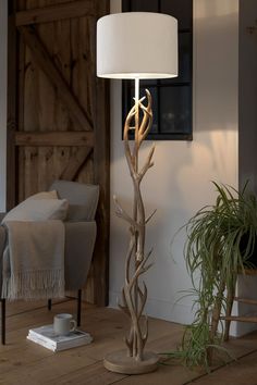 a lamp that is on top of a wooden table next to a couch and chair