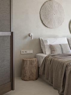 a bedroom with two circular wall hangings above the bed and pillows on the side