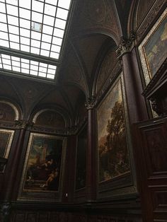 an ornate room with paintings on the walls and ceiling, along with a skylight