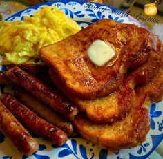 breakfast plate with sausages, scrambled eggs and french toast on blue and white plate