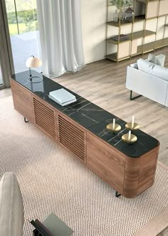 a living room with a couch, coffee table and bookshelf on the floor