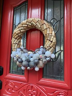 a red door with a wreath on it