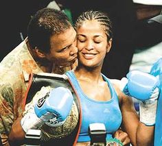 a man kissing a woman with boxing gloves on