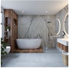 a bathroom with marble walls and flooring next to a bathtub in the corner