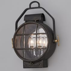 an old fashioned wall light with three lights on it