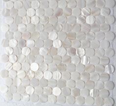 a white tile with shells on it