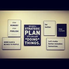 some signs are hanging on the wall in front of a bulletin board that says, we have a strategy plan it's called doing things