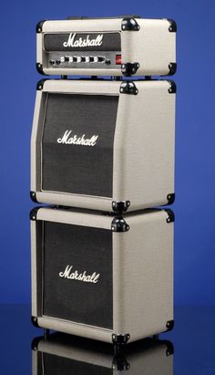 two marshall amps stacked on top of each other in front of a blue background