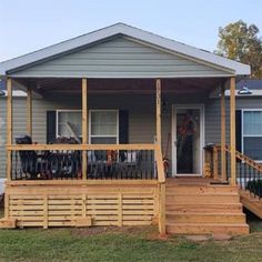 a small house with a porch and wooden steps