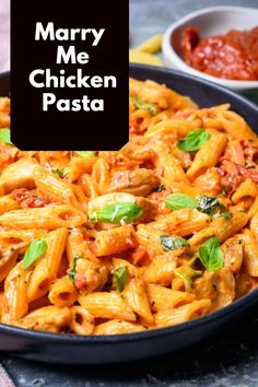 a pan filled with pasta and sauce on top of a table