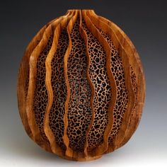 a wooden vase with an animal print design on it