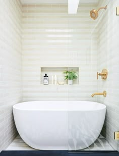 a white bath tub sitting inside of a bathroom