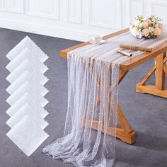 the table is covered with white sheer fabric