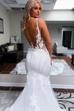 a woman in a white wedding dress looking back