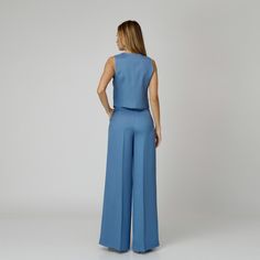 Introducing our Skye Silk Crepe Pants, a statement of luxurious comfort and timeless style. Tailored from  blue silk crepe with a wide-leg cut, they feature expertly placed darts that contour the waist and flatter the silhouette. The pressed crease detail offers a touch of refinement, elevating the overall look with understated polish. A concealed zipper and hook fastening in the front ensures a seamless finish, while the inclusion of pockets adds a practical yet chic element to the ensemble.  M Elegant Ankle-length Viscose Wide Leg Pants, Tailored Wide-leg Blue Dress Pants, Blue Tailored Wide-leg Dress Pants, Elegant Wide Leg Viscose Pants, Elegant Full-length Blue Dress Pants, Elegant Blue Full-length Dress Pants, Tailored Blue Wide Leg Pants For Formal Occasions, Tailored Wide Leg Blue Pants For Formal Occasions, Blue Silk Wide-leg Bottoms