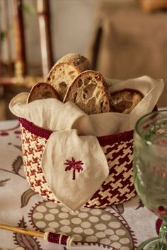 a basket filled with bread sitting on top of a table