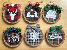 four christmas ornaments hanging from rope on a table