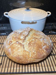 a loaf of bread sitting on top of a cooling rack in front of an oven