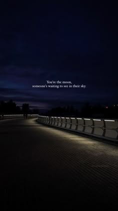 an empty walkway at night with the quote you're the moon