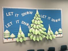 a bulletin board with paper snow trees on it