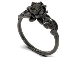 If you're looking for an engagement ring like no other, stop right here. This AMAZING piece of fine jewelry is the perfect expression of your eternal love. Its BLACK colors bring out the beauty of this ring. This engagement ring is created of gleaming, 14kt black gold, carved into an elaborate leaf design at the top. A striking black diamond sits boldly at the center, surrounded by black gold petals, forming the eye-catching image of a lotus flower.  לטבעת תואמת לחץ על הלינק: Sku Number: Fle24bb Gem Details:  Center Gem: Diamond (Natural)  Carat Weight:  CT  mm  Color/Clarity: Black / AAAA Size/Cut/Shape: Round, very good  Necklace Details: Metal/weight/detail: 14K Black Gold (Black rhodium plated over 14K white gold) * Ask for different karat pricing. Shipping time: 2 weeks Need it rushed Black Gold Rings Women, Black Vintage Ring, Black Silver Ring, Gold And Black Engagement Ring, Dark Engagement Ring Black Diamond, Black Rings Aesthetic, Black Gold Rings, Black Rings For Women, Black Wedding Ring Sets