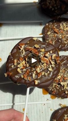 chocolate covered donuts on a stick with nuts