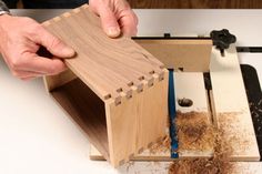 a person working with woodworking tools on a piece of furniture that is being worked on